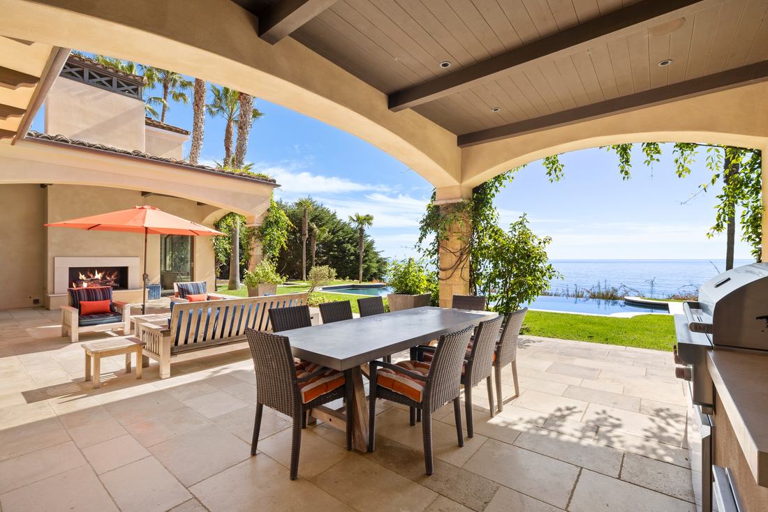 The lanai: dining terrace, built-in grill, courtyard fireplace